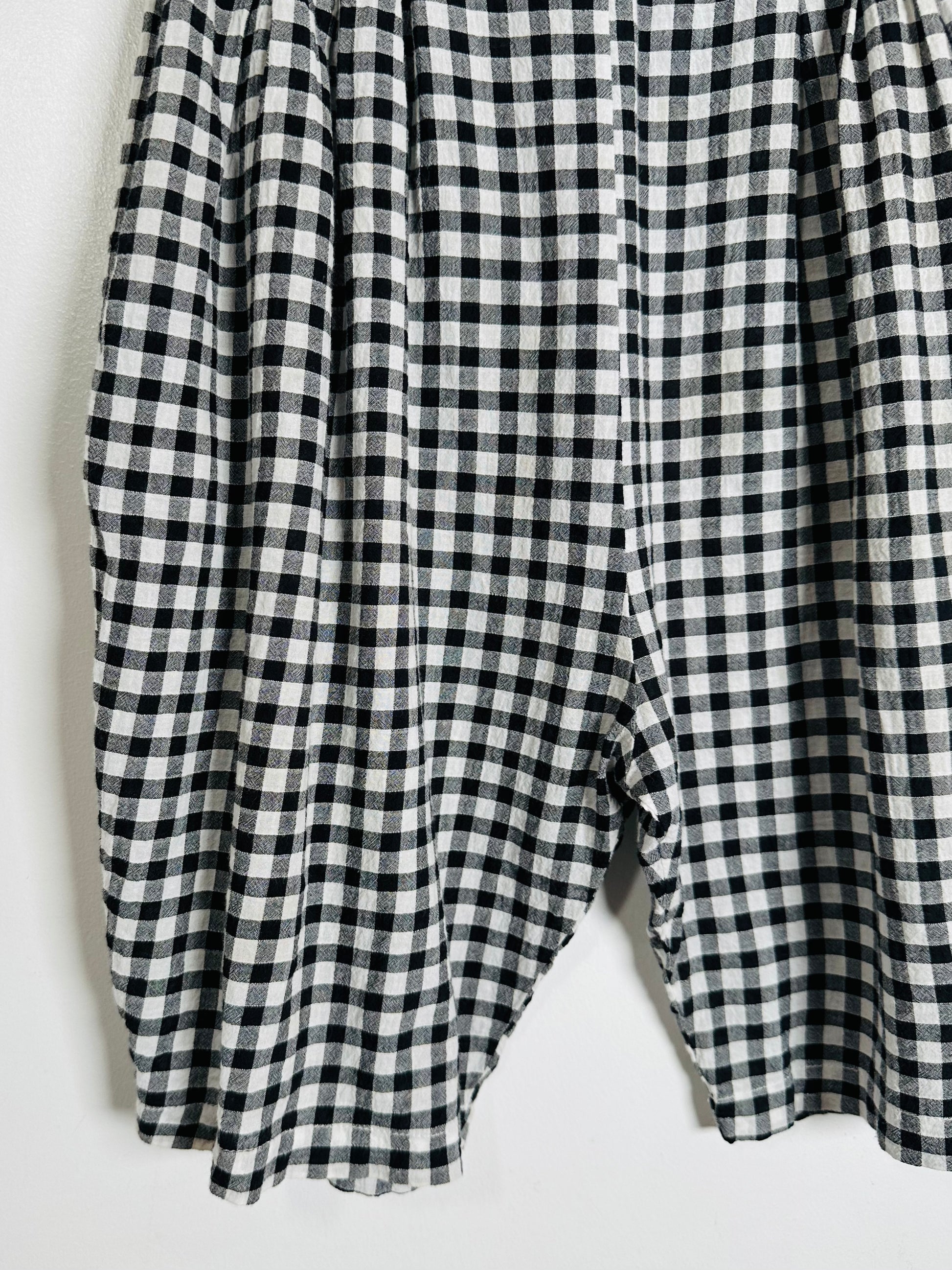 Black and white checkered pants on a light gray background