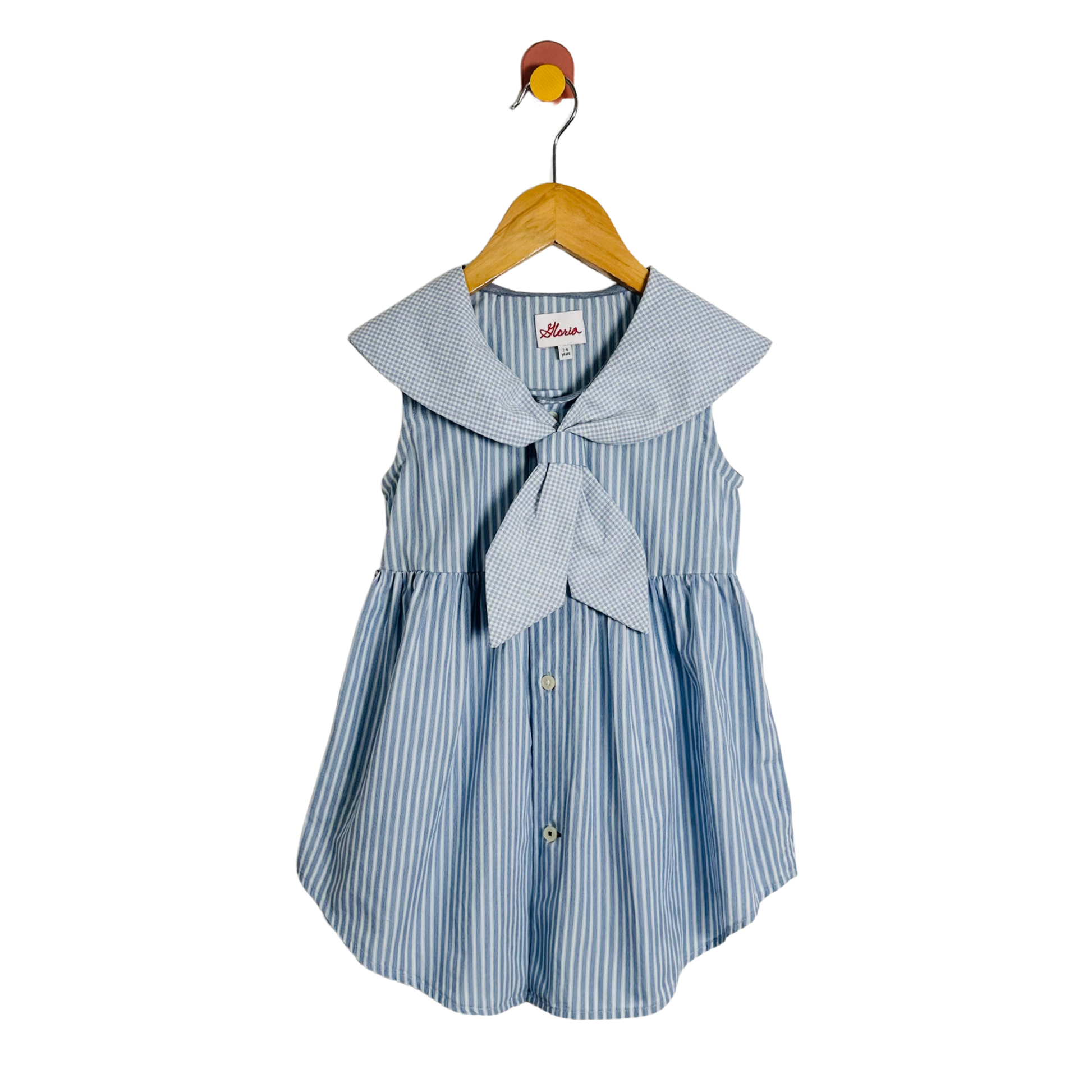 Blue and white striped dress with a bow on a wooden hanger against a white background