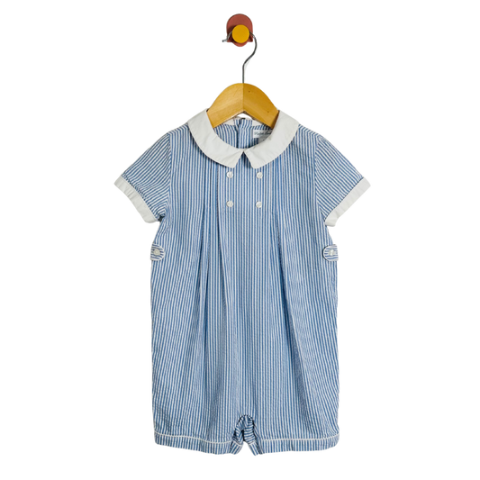 Blue striped baby romper with white collar on a hanger against a white background