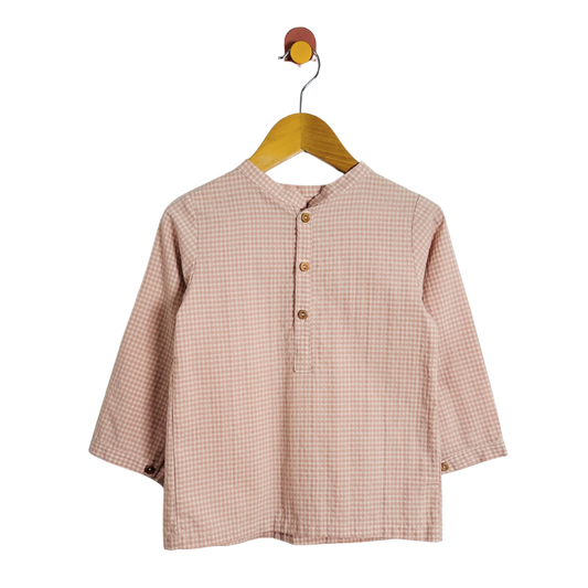 Checkered shirt on a hanger against a white background