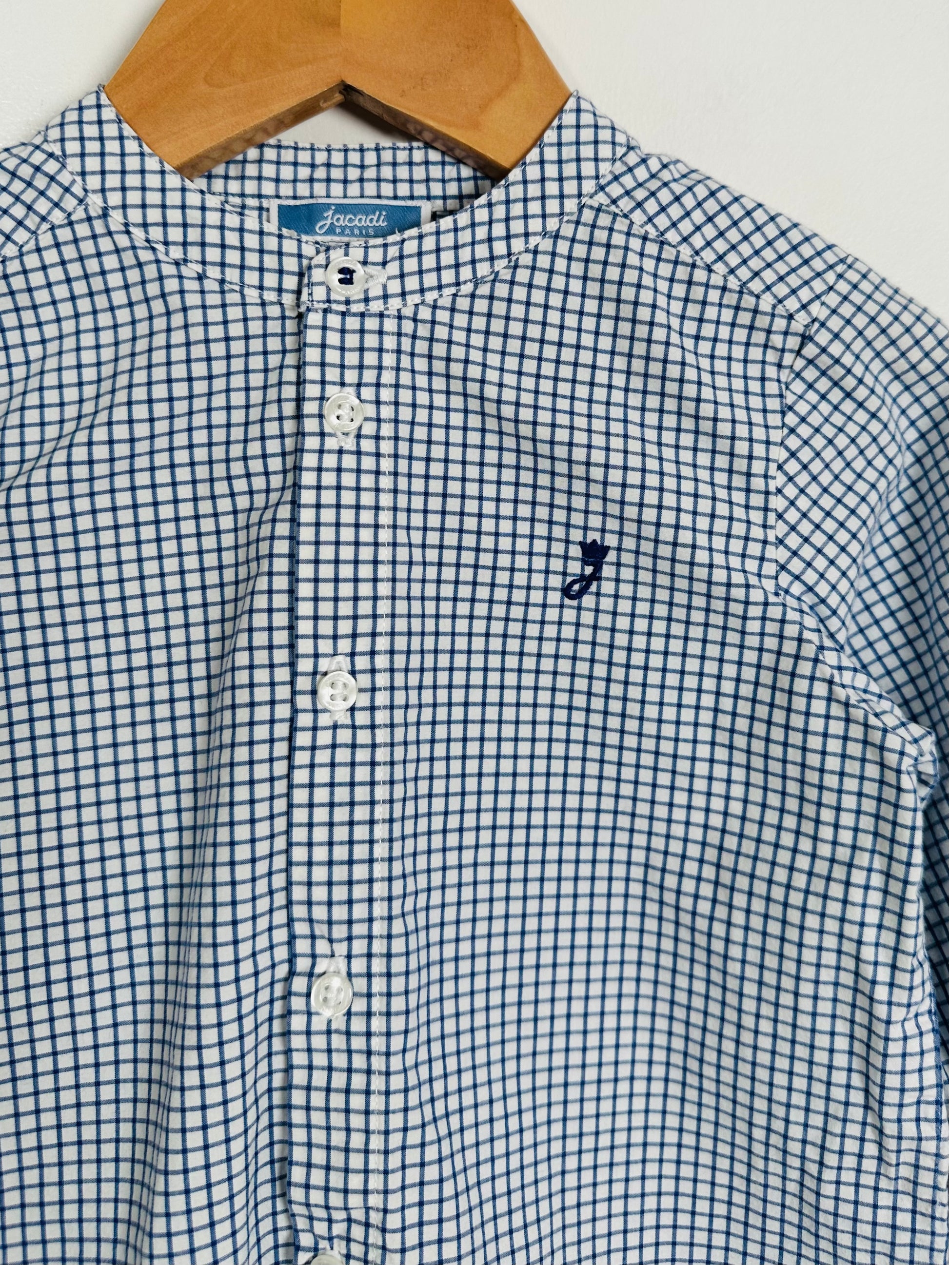 Blue and white checkered shirt with a small logo on a hanger