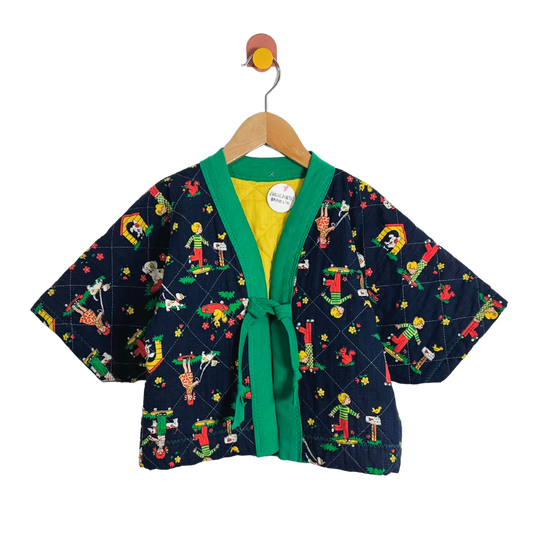 Children's kimono-style jacket with colorful pattern on a hanger against a white background