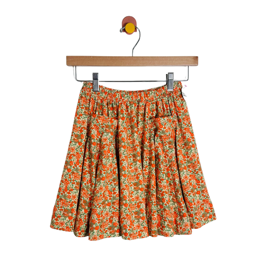 Floral skirt on a hanger against a white background