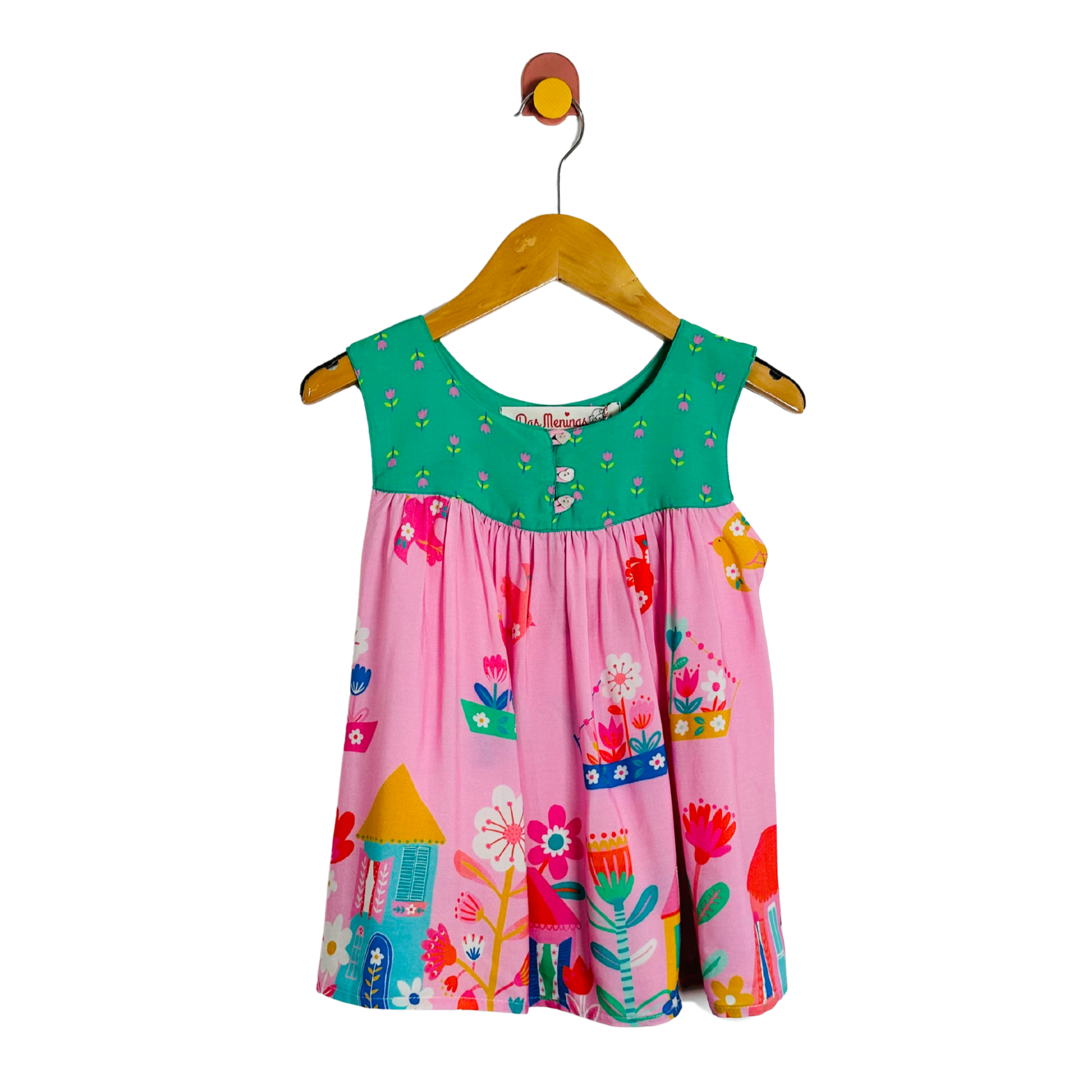 Colorful children's top on a hanger against a white background
