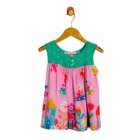 Colorful children's top on a hanger against a white background