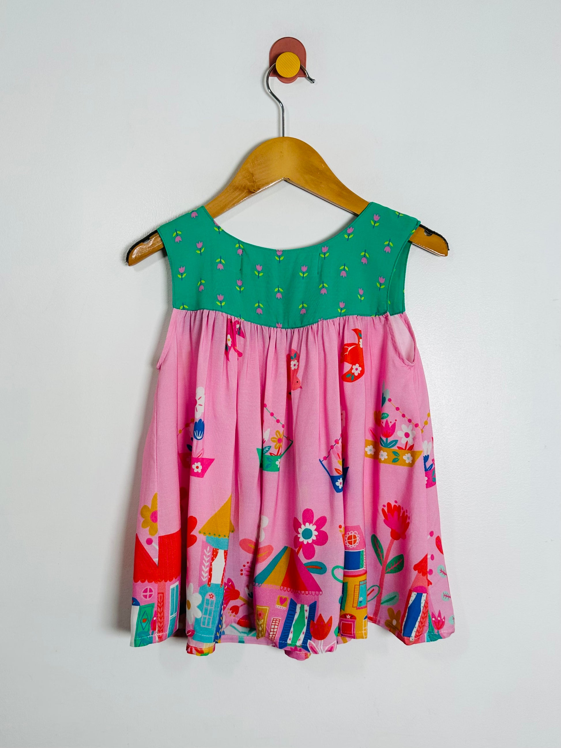 Colorful dress a hanger against a white background