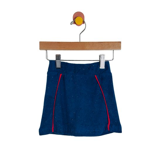 Blue skirt with red accents on a wooden hanger against a white background