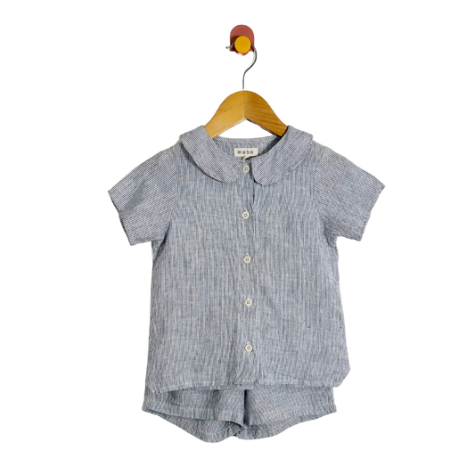 Children's blue striped shirt and shorts set on a hanger against a white background