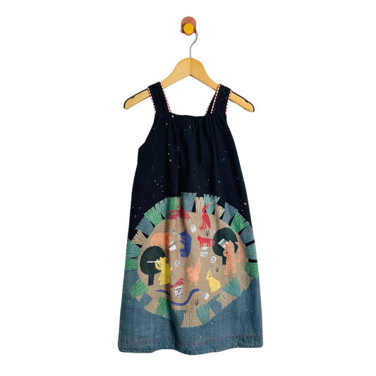 Black dress with colorful design on a hanger against a white background