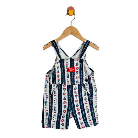 Children's nautical-themed overalls on a hanger against a white background