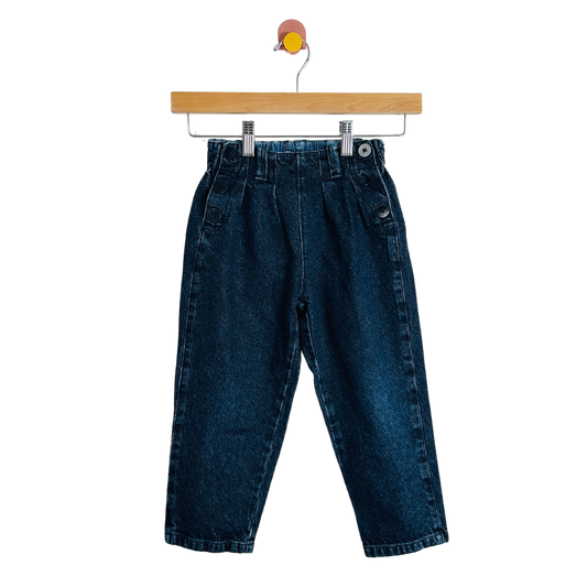 Blue jeans on a wooden hanger against a white background