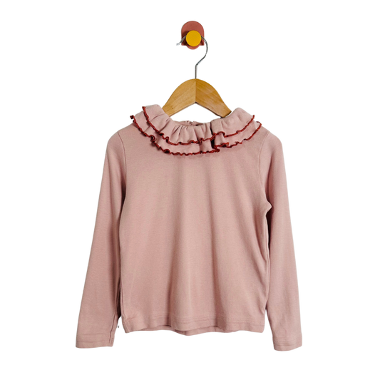 Pink long-sleeve top with ruffled collar on a hanger against a white background
