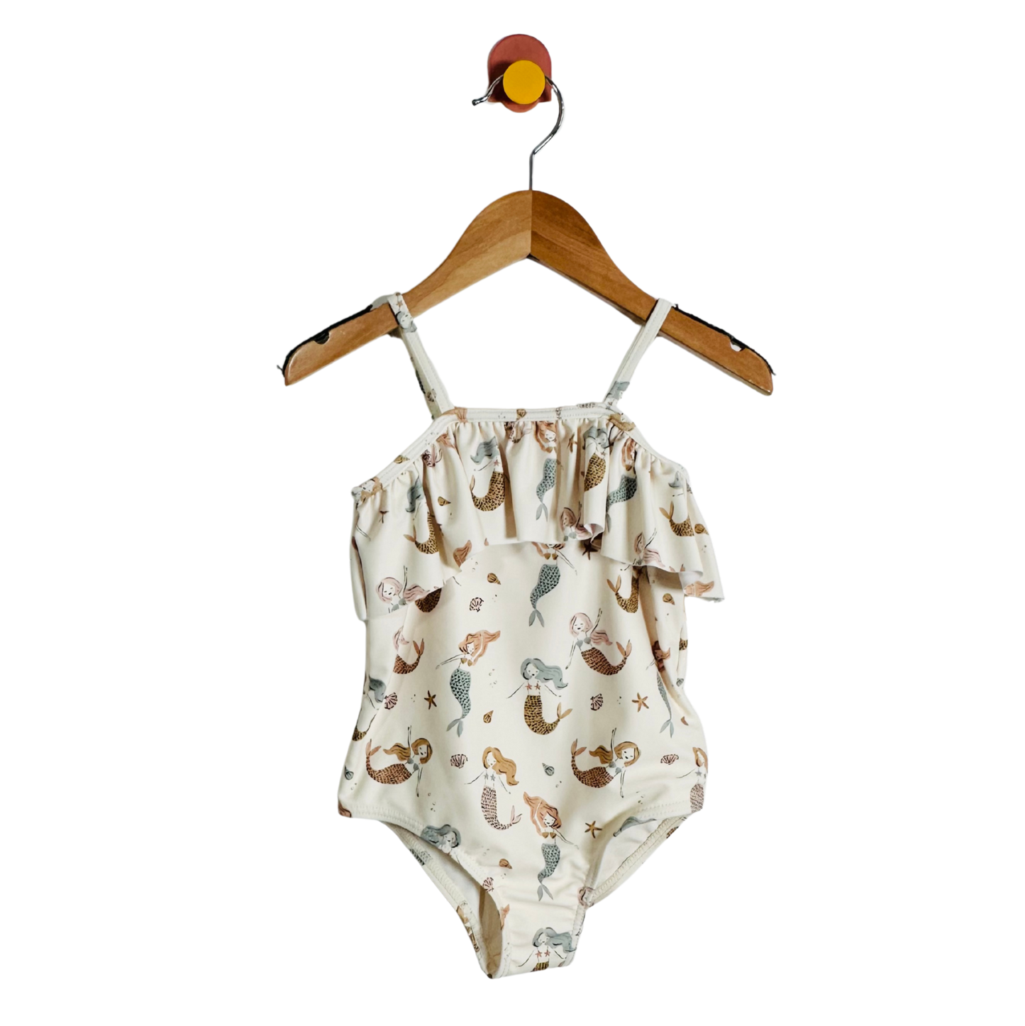 Swimsuit with mermaid pattern on a hanger against a white background