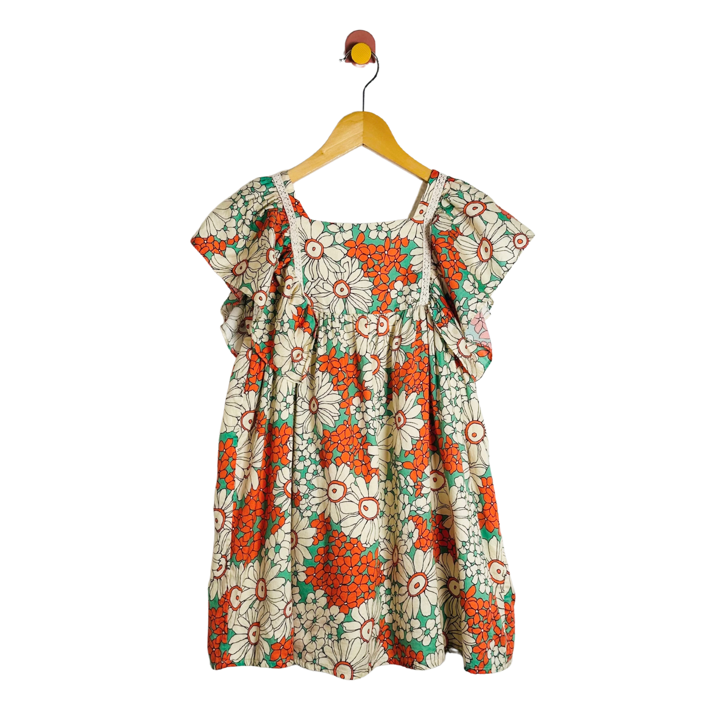 Floral dress on a hanger against a white background