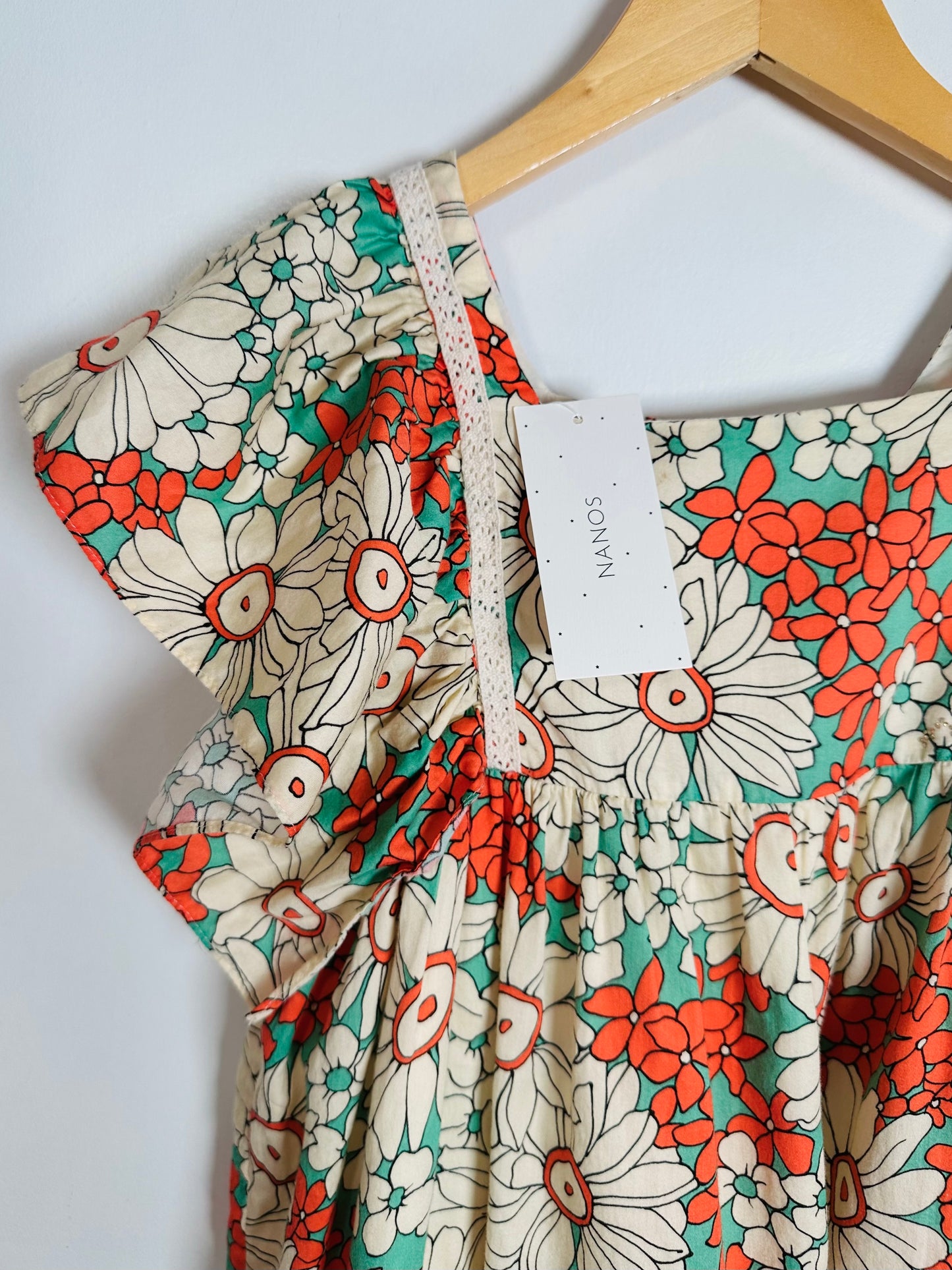 Floral dress with a tag on a white background
