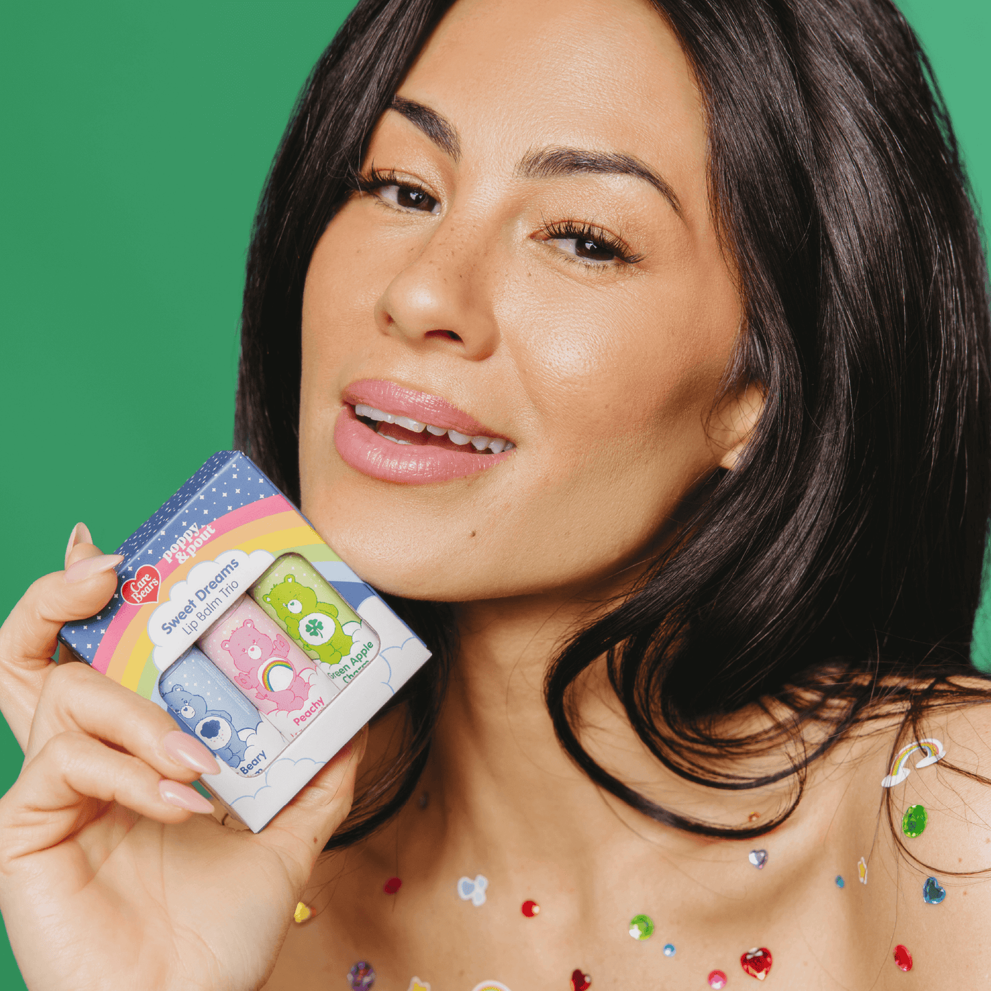 Woman holding a colorful product package against a green background