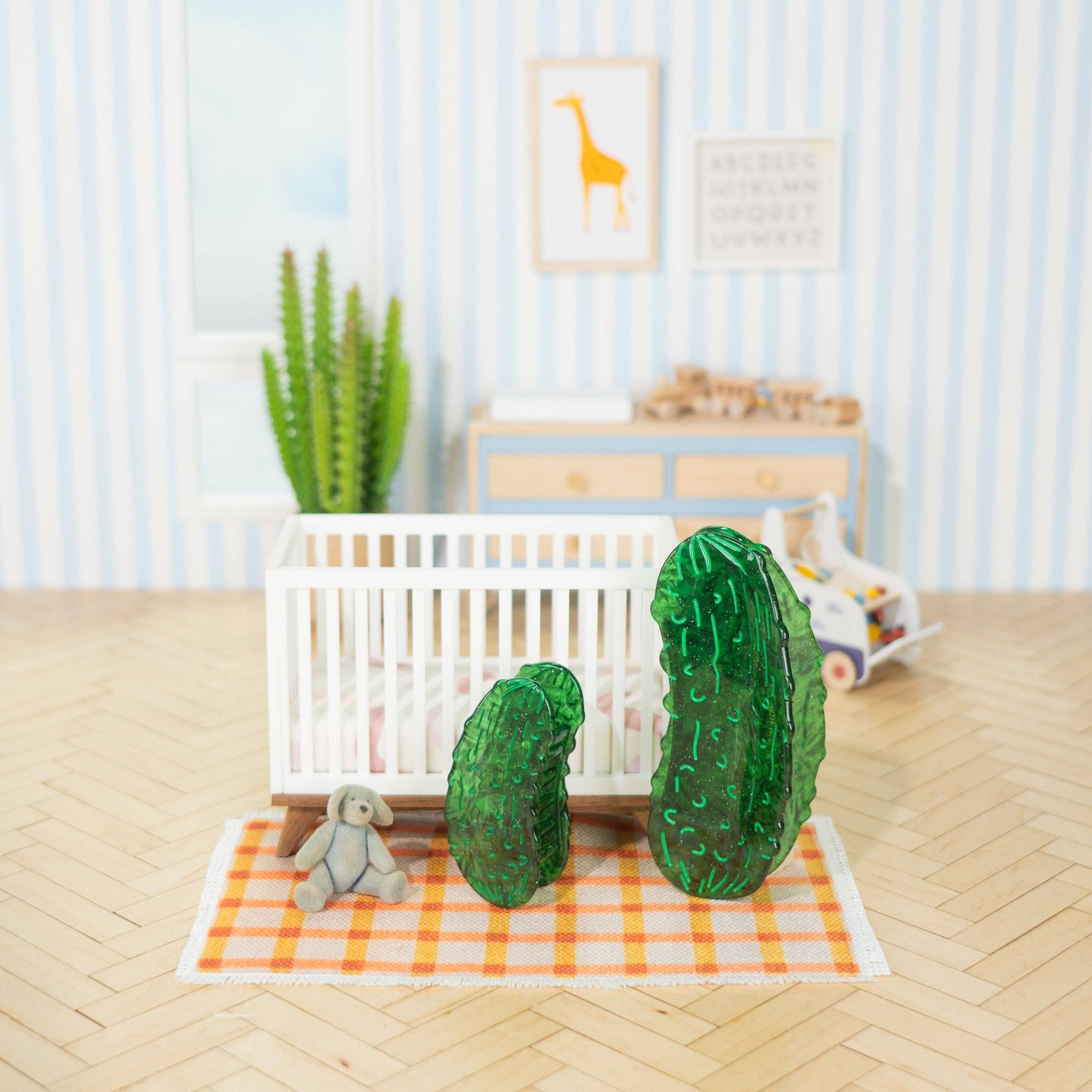 Nursery room with crib, toys, and decorative items on a checkered rug.