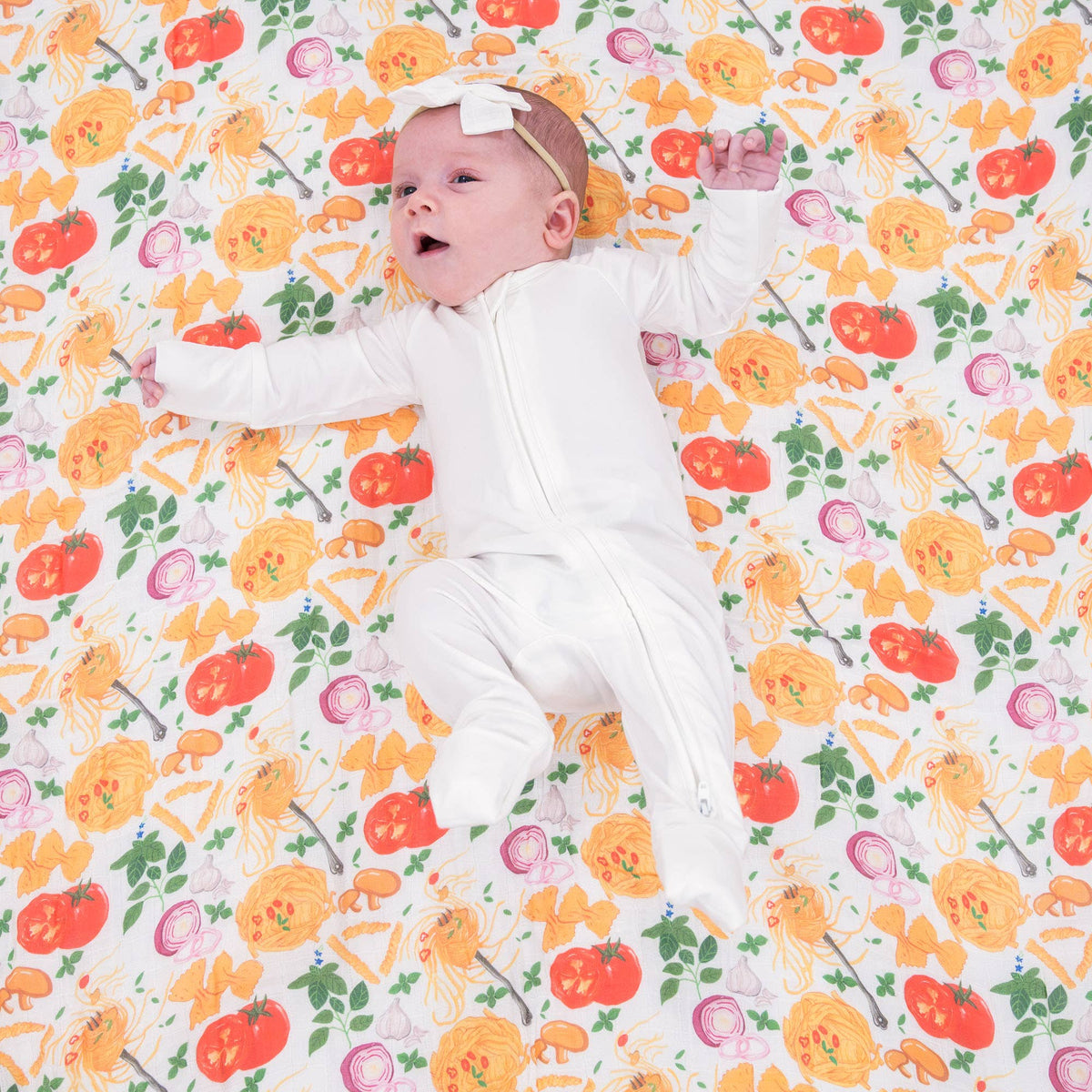 Baby lying on a colorful patterned blanket