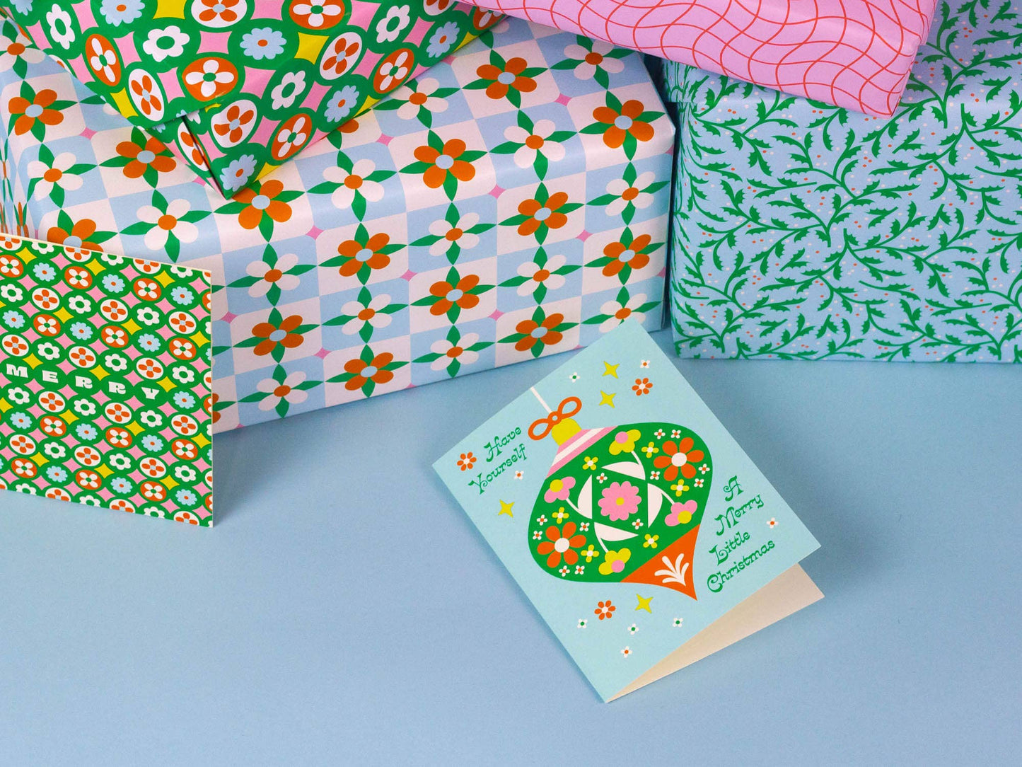 Colorful patterned paper and a greeting card on a blue background