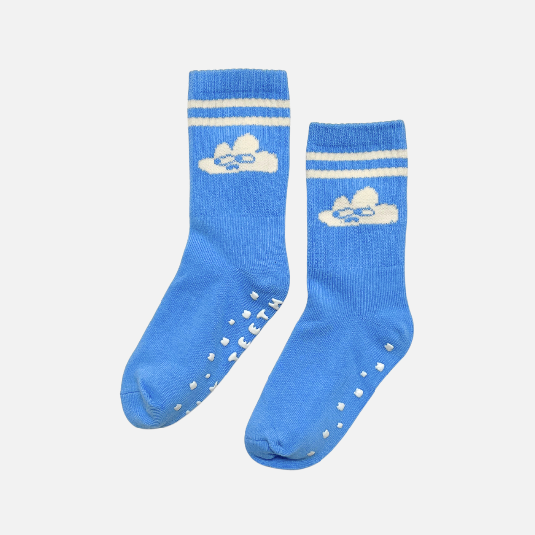 Pair of blue socks with white stripes and cloud design on a light gray background