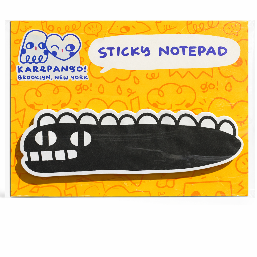 Sticky notepad with a cartoon alligator design on an orange background, featuring the brand 'Karepango!'.