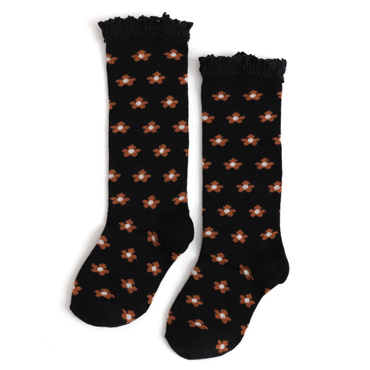 Black socks with brown flower pattern on a white background
