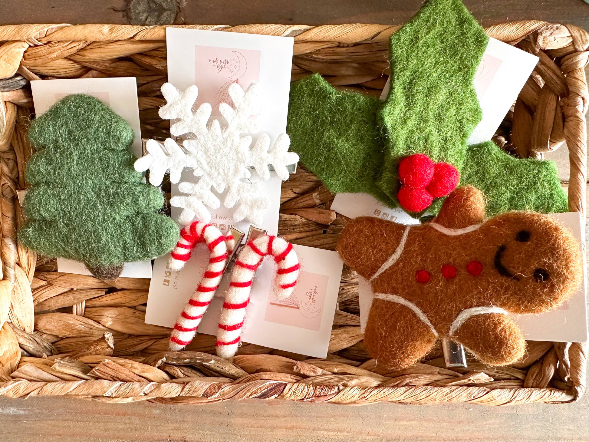 Decorative items including a gingerbread man, candy canes, snowflake, and holly leaves in a woven basket.