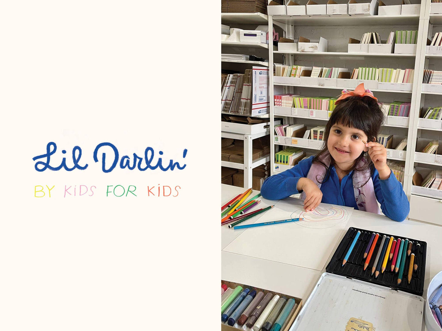 Child sitting at a table with art supplies in a library setting, featuring 'Lil Darlin' branding.