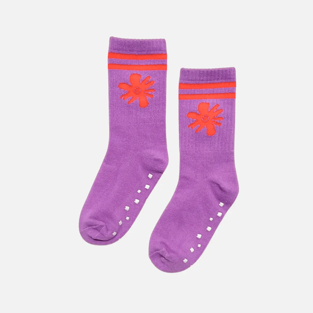 Purple socks with orange flower designs and striped patterns on a white background