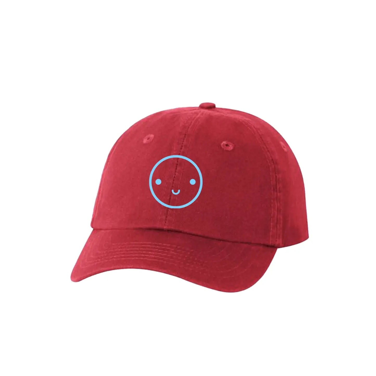 Red cap with a blue smiley face design on a white background
