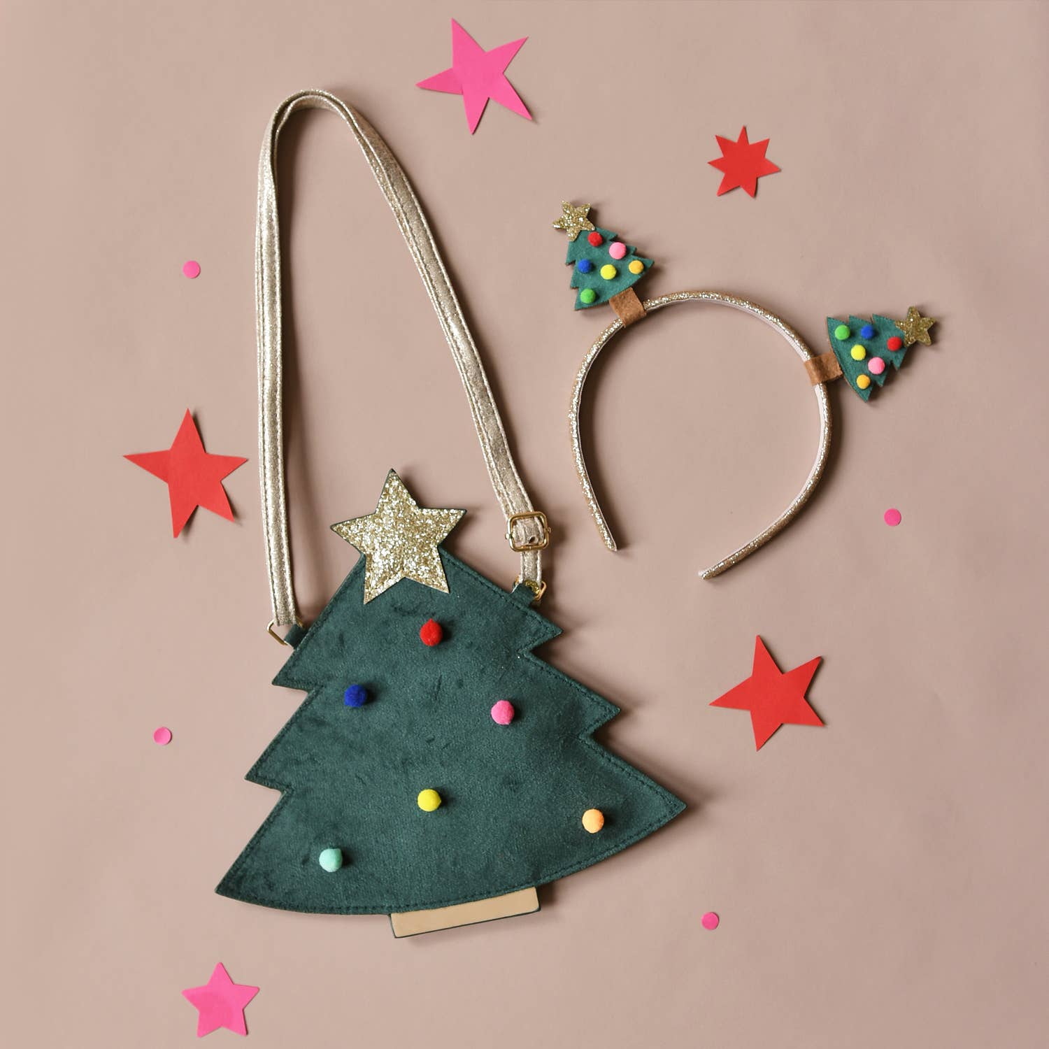 Christmas tree-shaped bag and headband with decorative trees on a beige background with star and tree confetti.