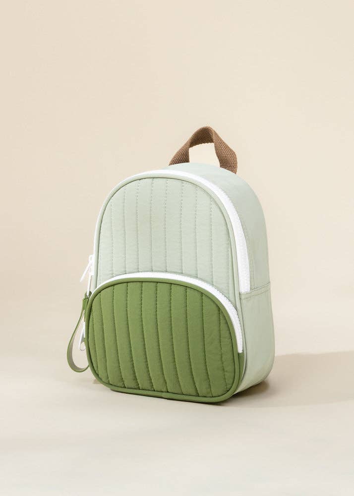 Green and white backpack on a beige background
