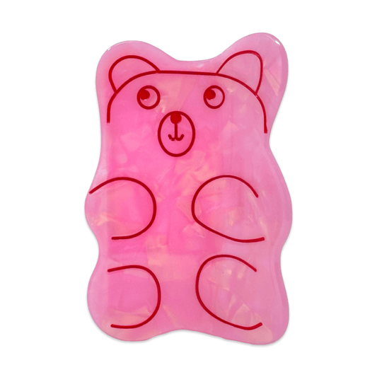Pink bear-shaped hair clip on a white background