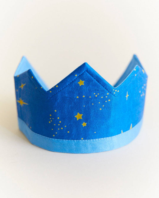 Blue silk crown with gold stars on a white background