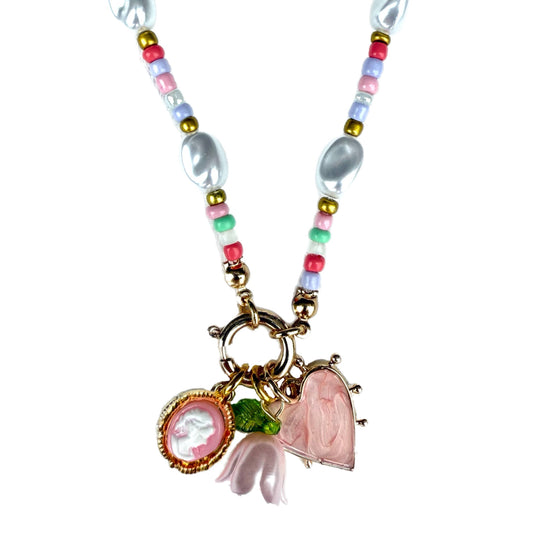 Necklace with colorful beads and floral charm on a white background