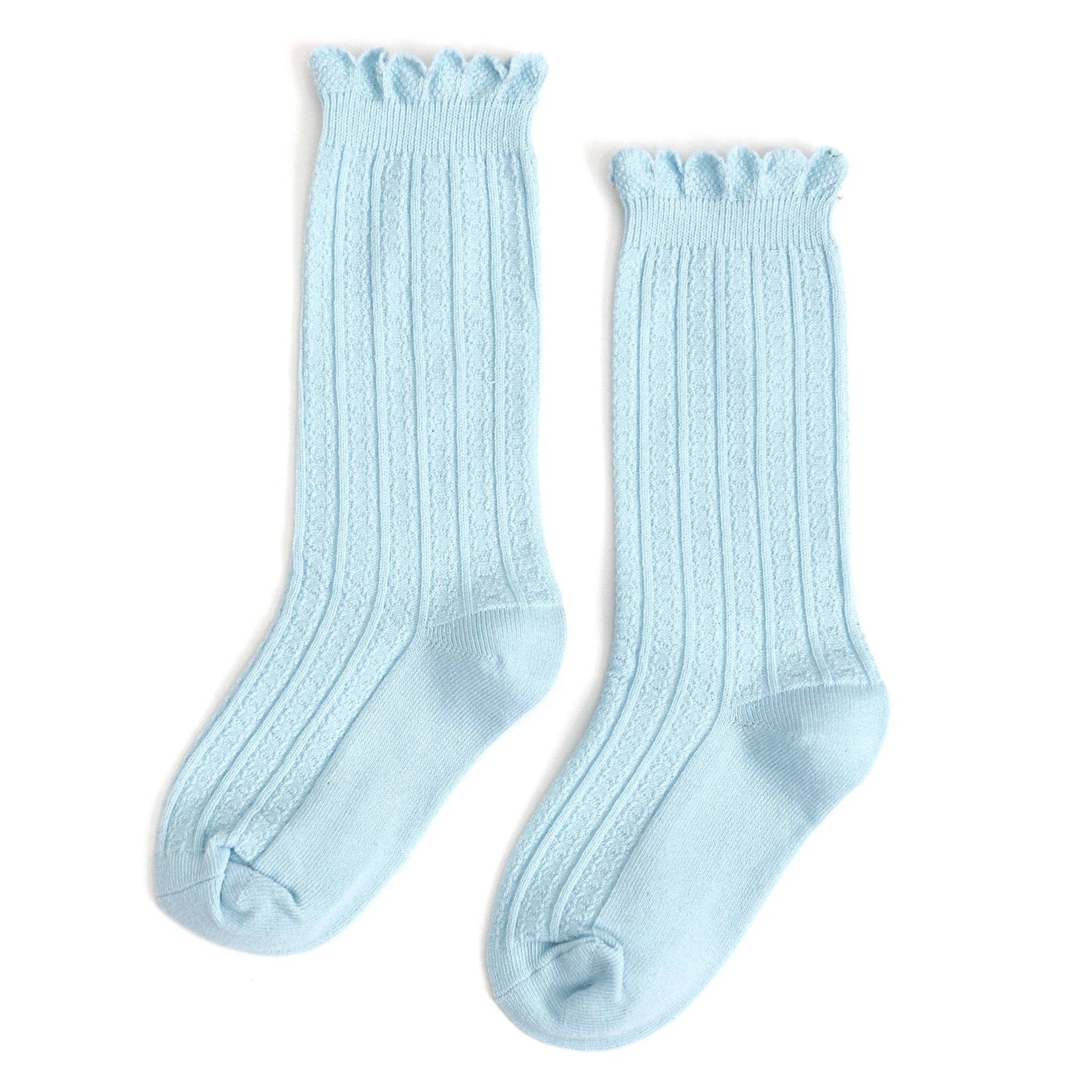 Pair of light blue knee-high socks on a white background