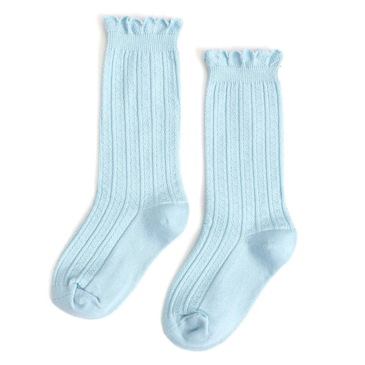 Pair of light blue knee-high socks on a white background