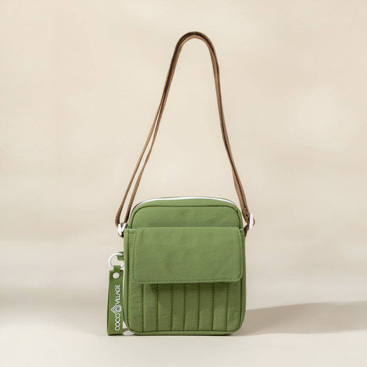 Green crossbody bag with a strap on a beige background
