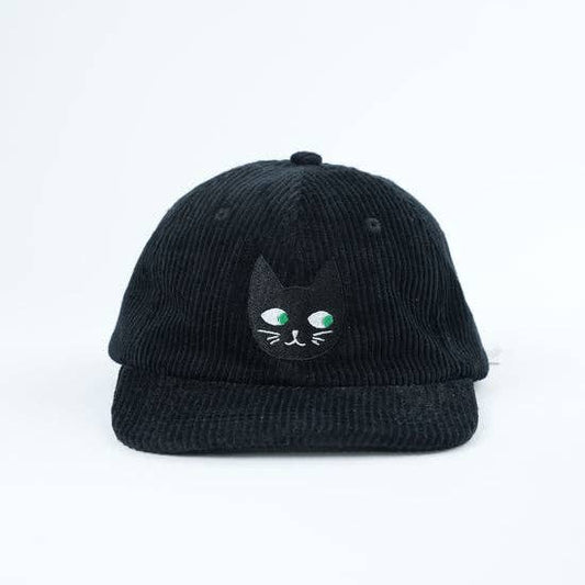 Black corduroy cap with a cat face design on a white background