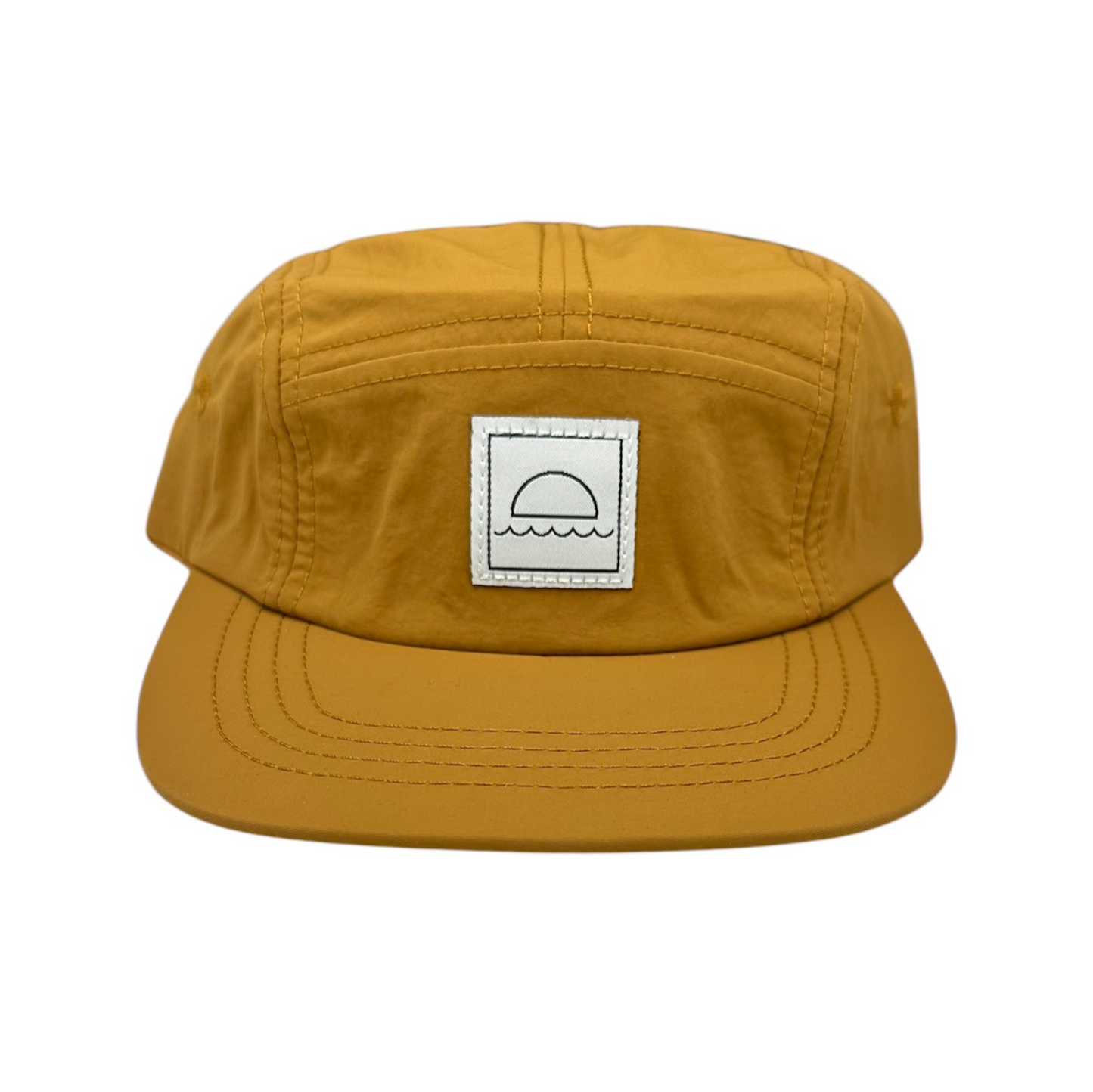 Mustard yellow cap with a logo patch on a white background