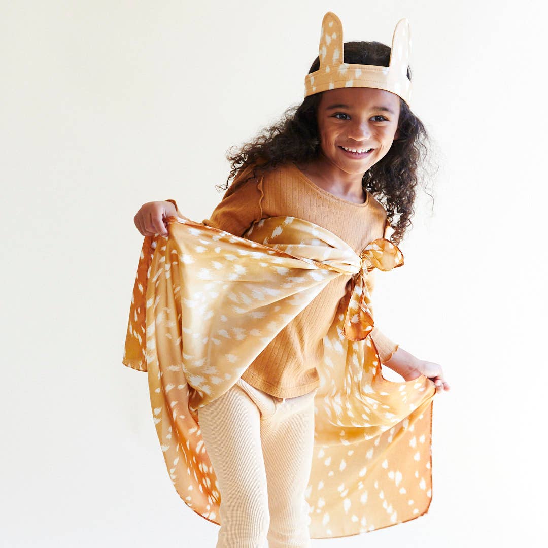 Child wearing a deer costume with a white background