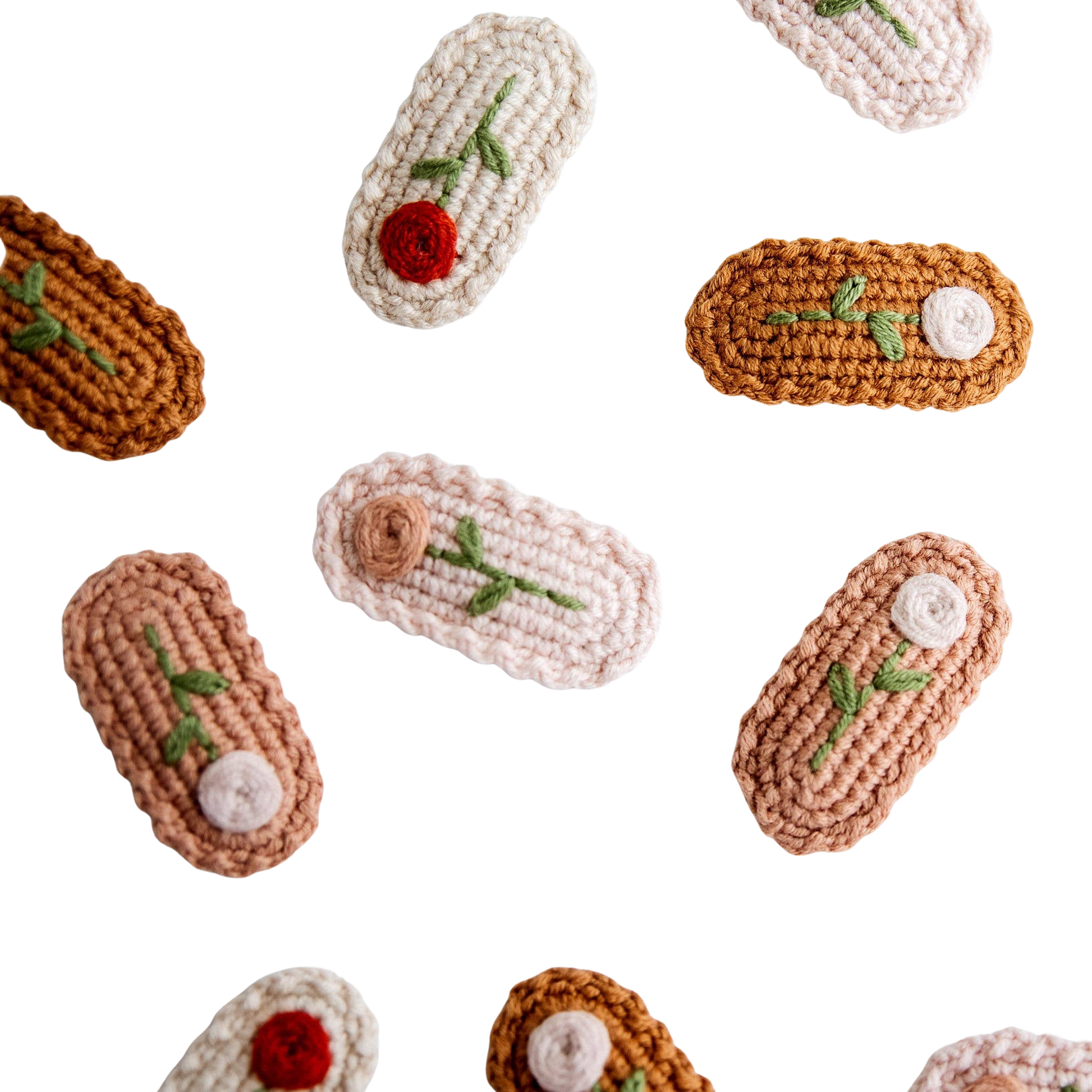 Crocheted hair clips with floral decorations on a light background