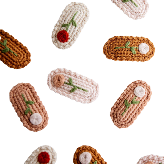 Crocheted hair clips with floral decorations on a light background