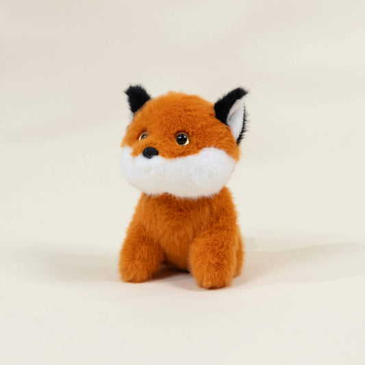 Plush fox toy on a beige background
