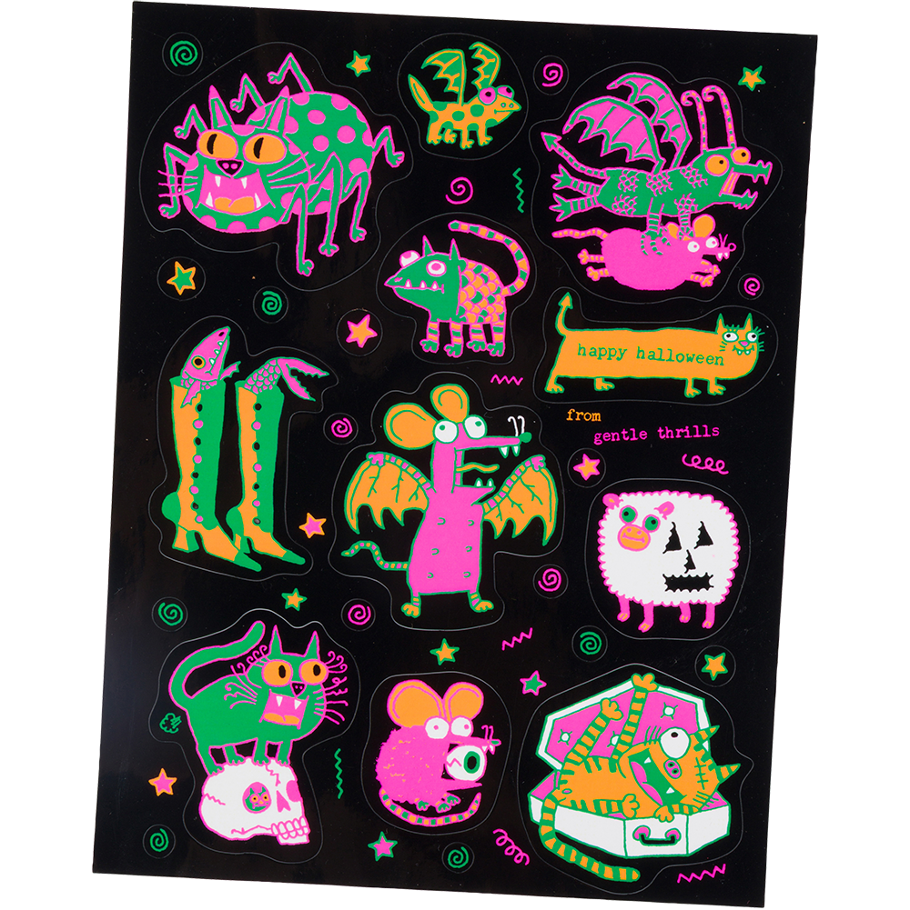 A sheet of colorful Halloween-themed stickers on a black backing, featuring whimsical monsters, stars, and text including 'Happy Halloween' and 'free genie turtle'.