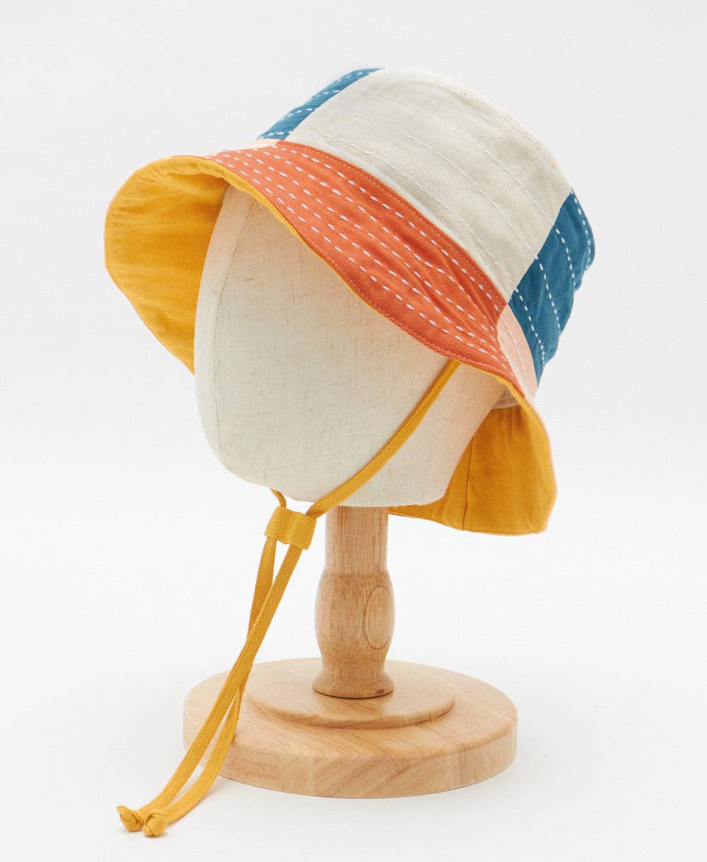 Colorful sun hat on a mannequin head with a white background