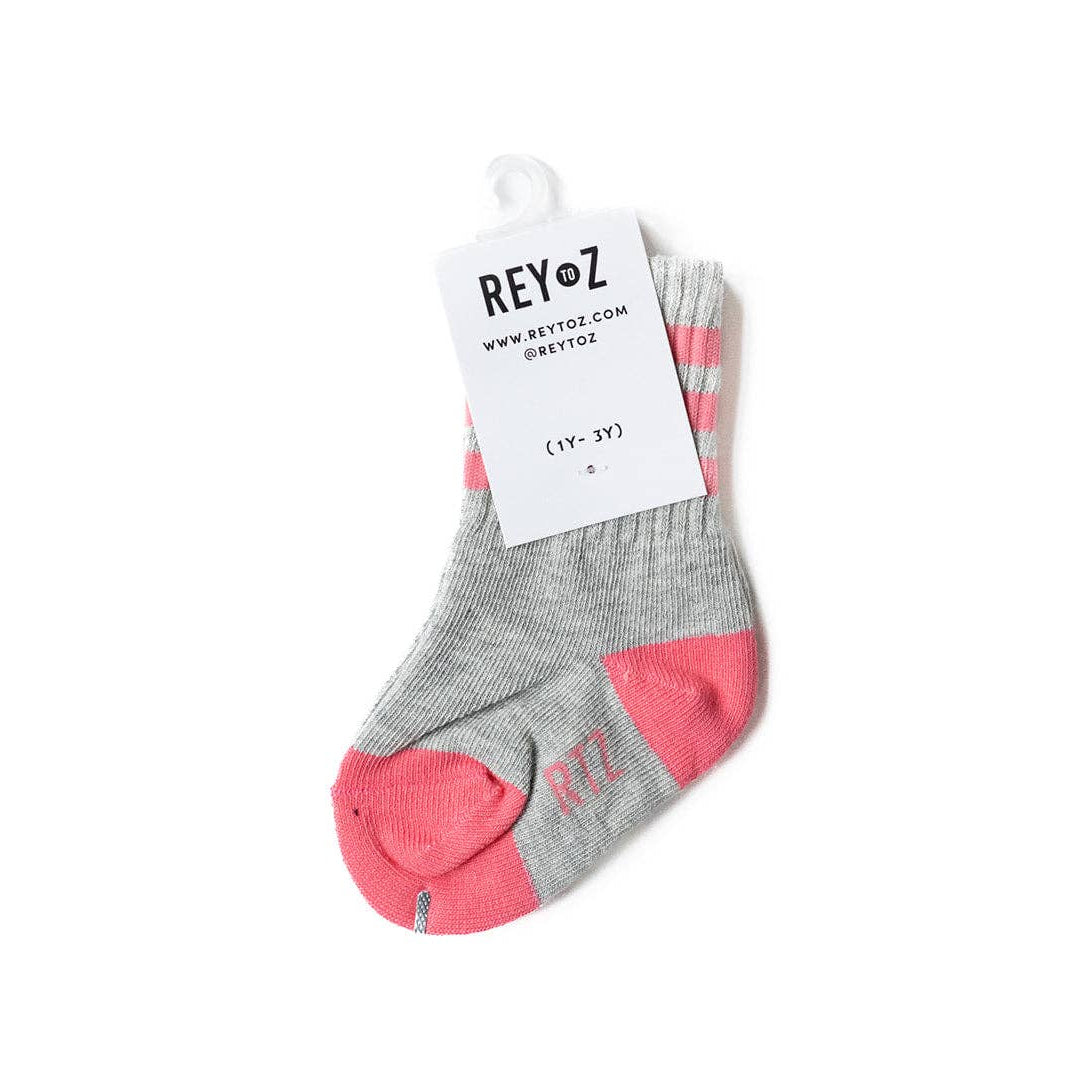 Gray and pink socks with a REY'OZ tag on a white background