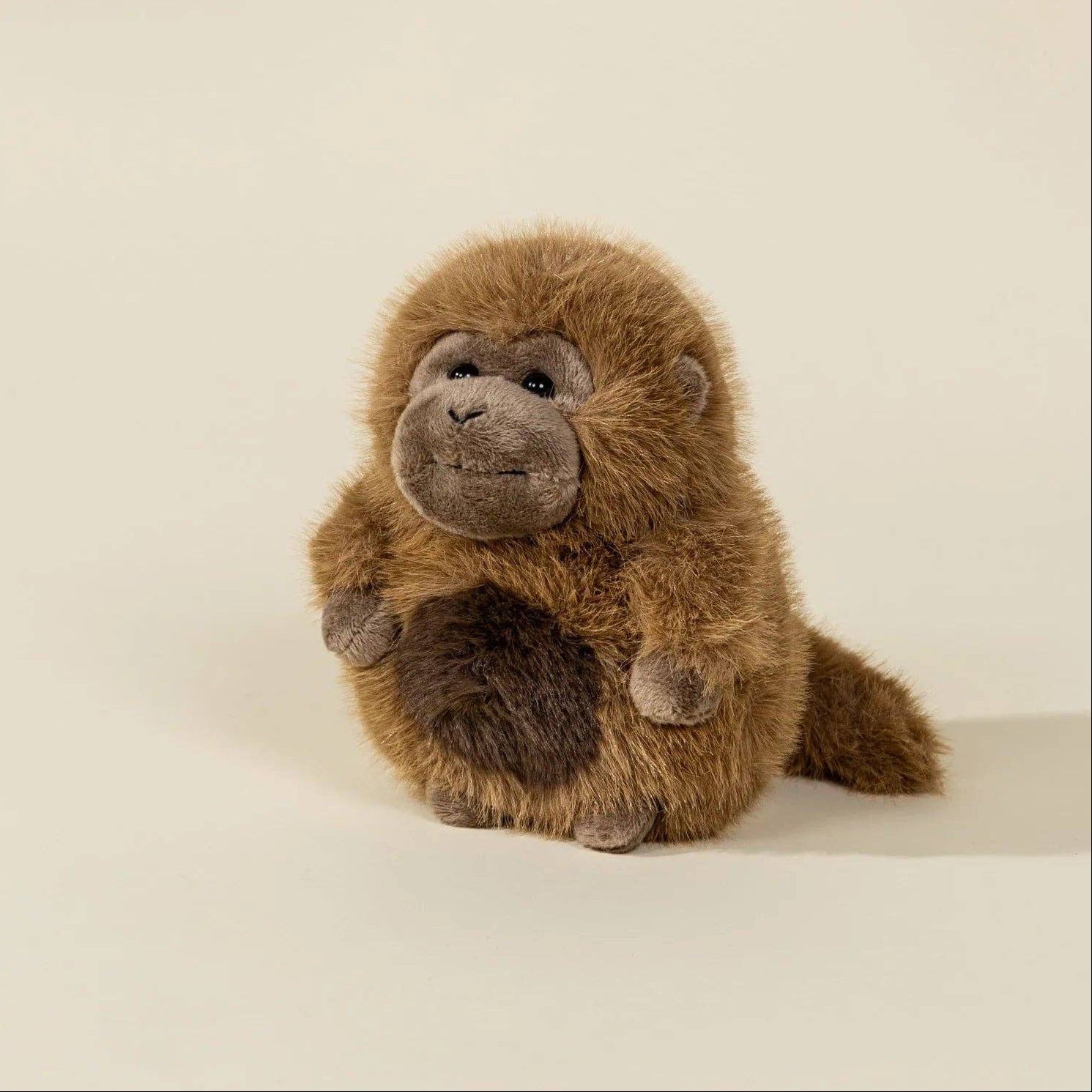 Stuffed monkey toy on a beige background