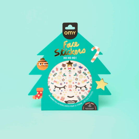 Packaged face stickers with a Christmas tree design on a light blue background
