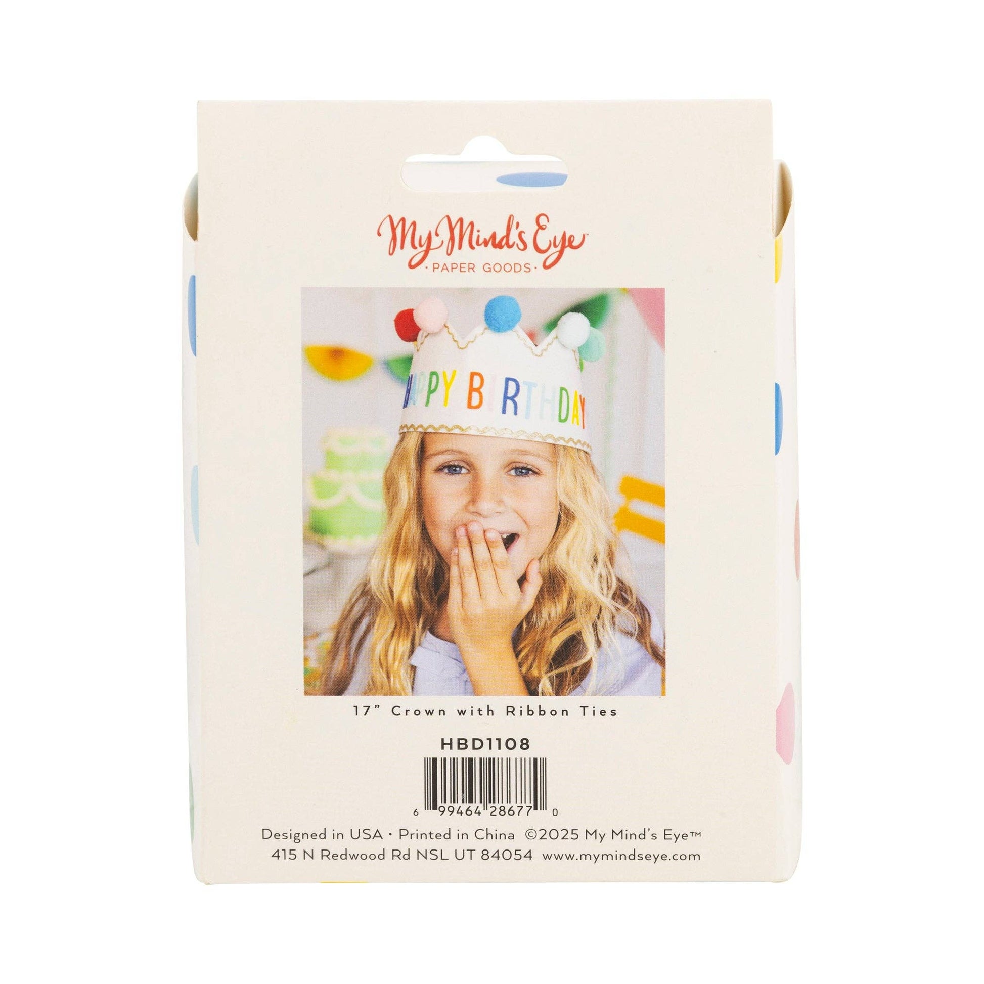 Packaging of a birthday crown with colorful ribbons and a photo of a child wearing it.